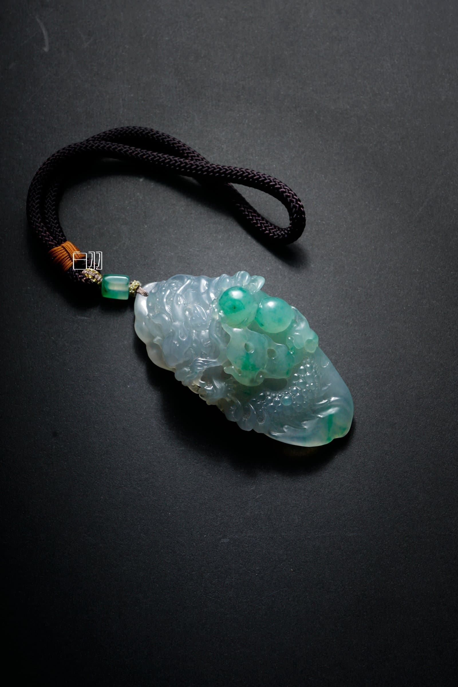 Icy Blue & Apple Green Auspicious Beast Jadeite Pendant in natural light