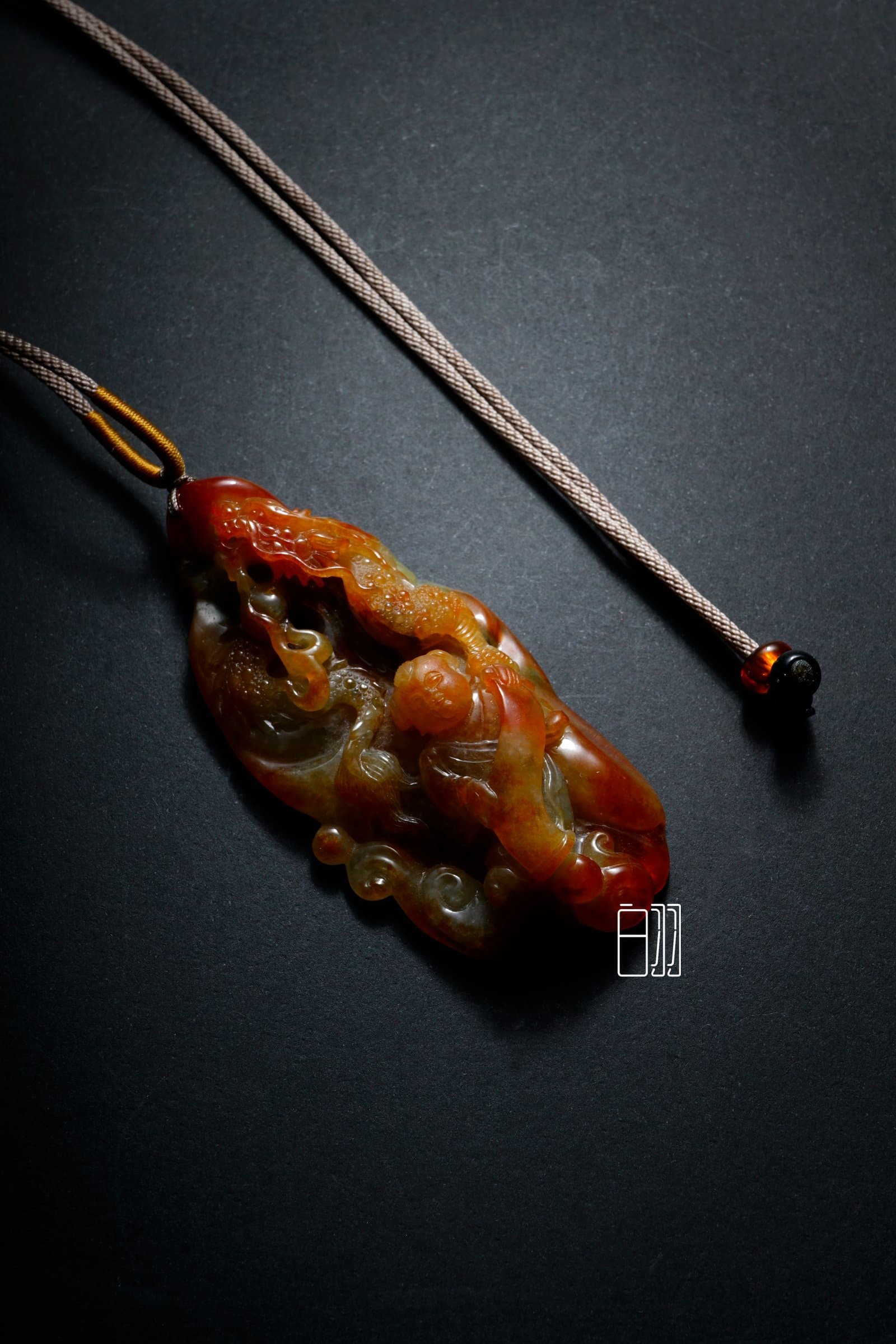 Red Jadeite Auspicious Dragon Guardian Pendant in natural light