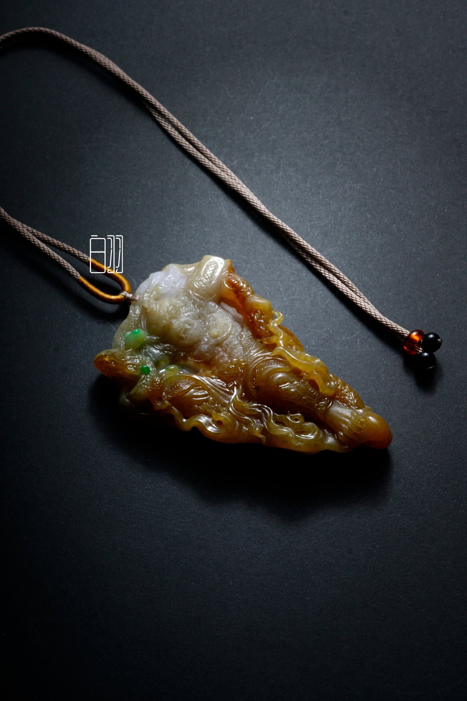 Two-Tone Mythical Beast Guardian Jadeite Pendant in natural light
