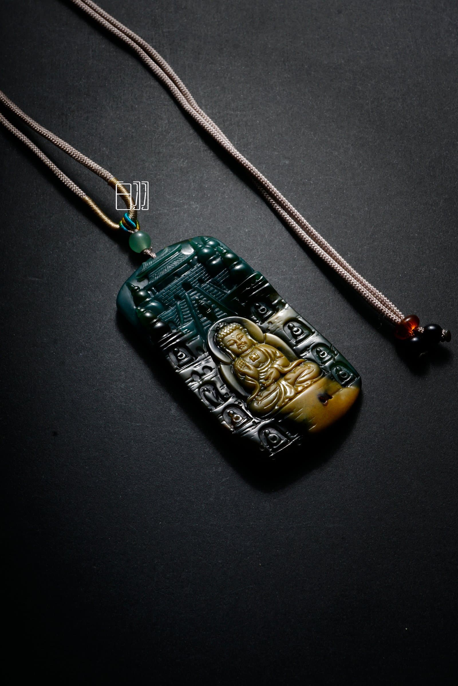Black Jadeite Zen Buddha Shadow Pendant in natural light