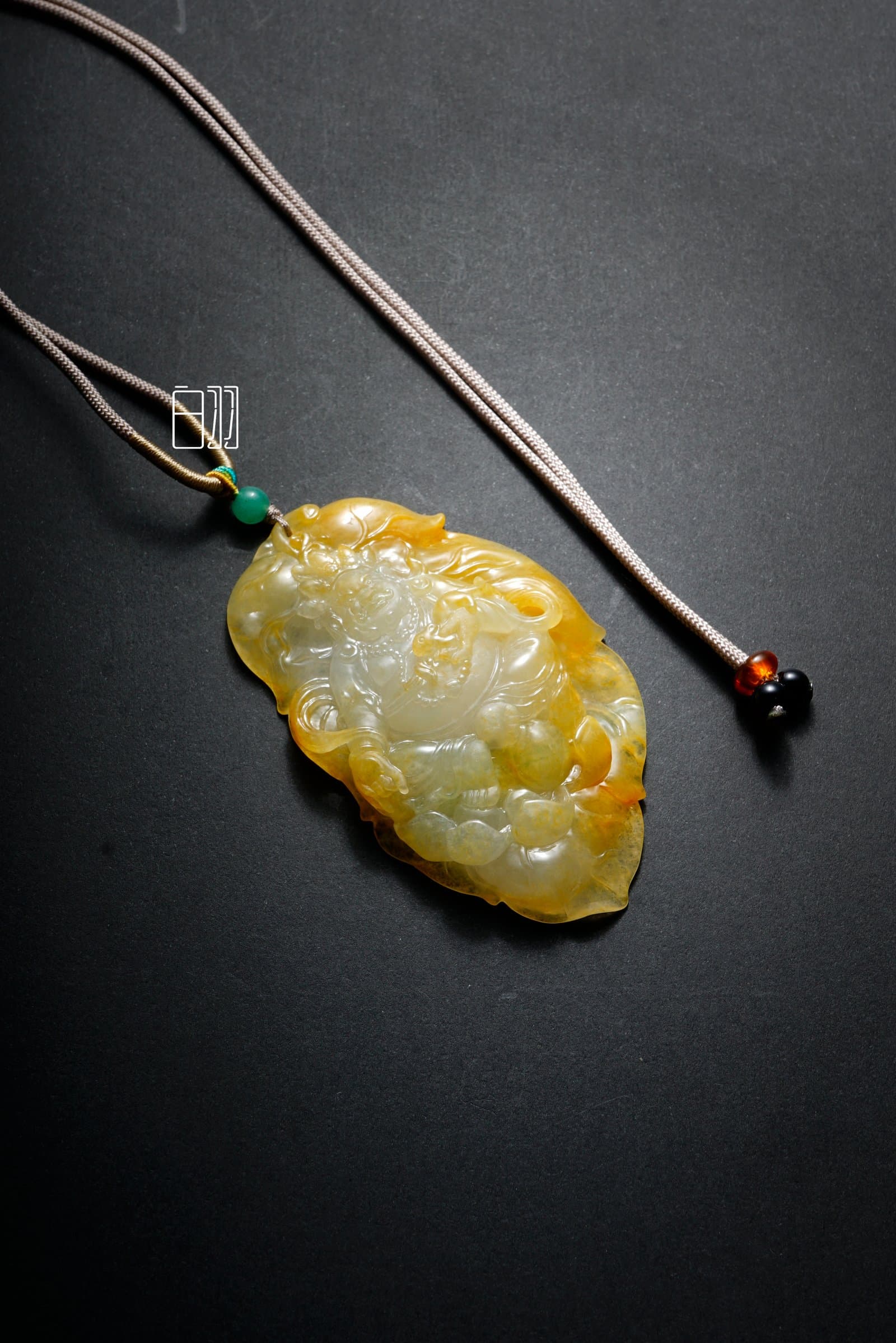 Imperial Yellow Jadeite Fortune Deity Pendant in natural light